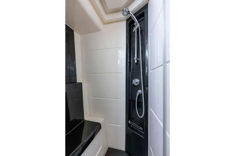 Slide: The Image of Luxurious shower area in 2015 Azimut 55S yacht, featuring sleek black and white design. - 29