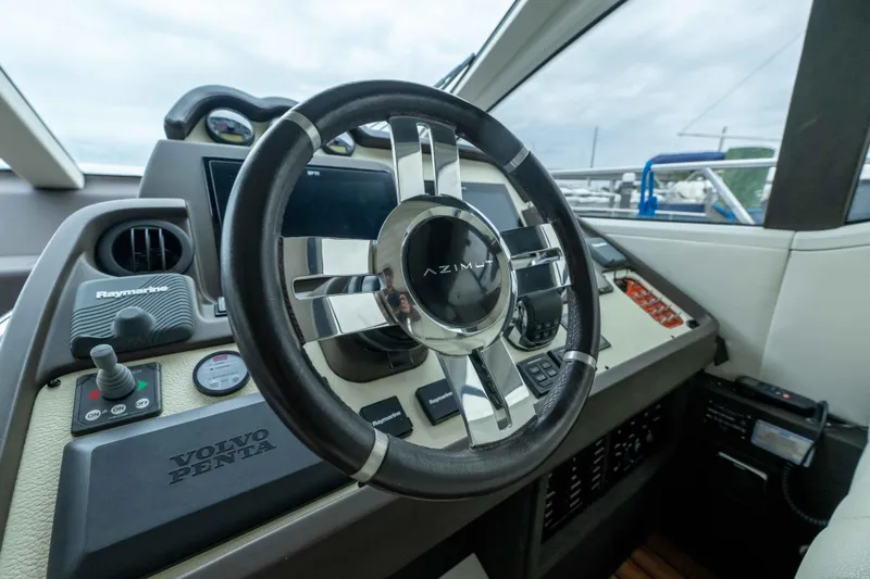 Slide: The Image of 2015 Azimut 55S yacht helm with steering wheel and control panel. - 39