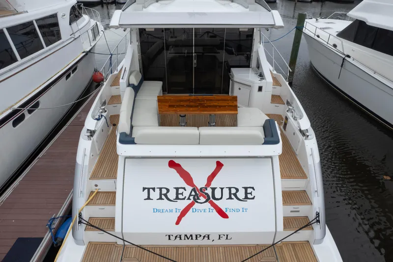 Slide: The Image of 2015 Azimut 55S yacht docked, featuring "Treasure" branding and Tampa, FL location. - 46