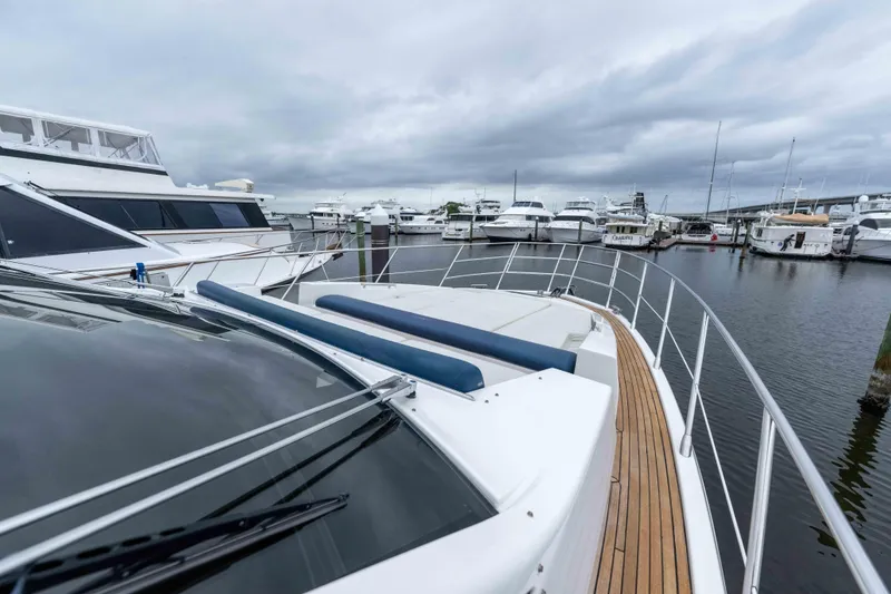 Slide: The Image of 2015 Azimut 55S yacht docked in a marina with cloudy skies. - 47
