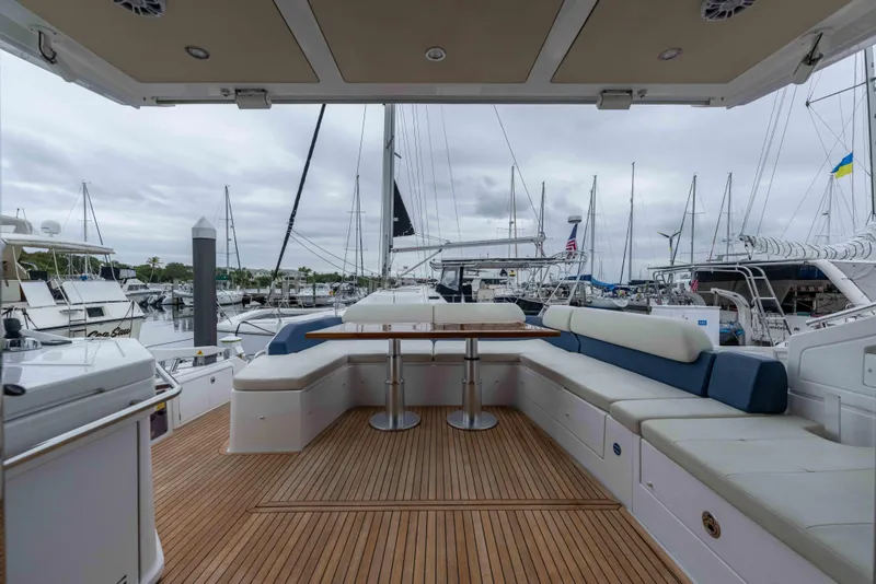 Slide: The Image of Luxurious 2015 Azimut 55S yacht deck with seating and table, docked at marina. - 60