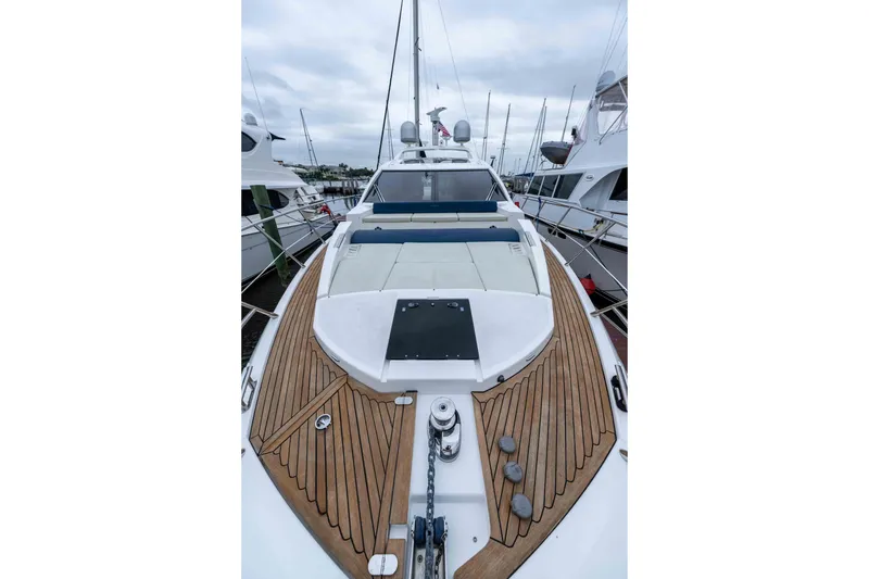 Slide: The Image of 2015 Azimut 55S yacht with sleek deck design, docked in a marina. - 64