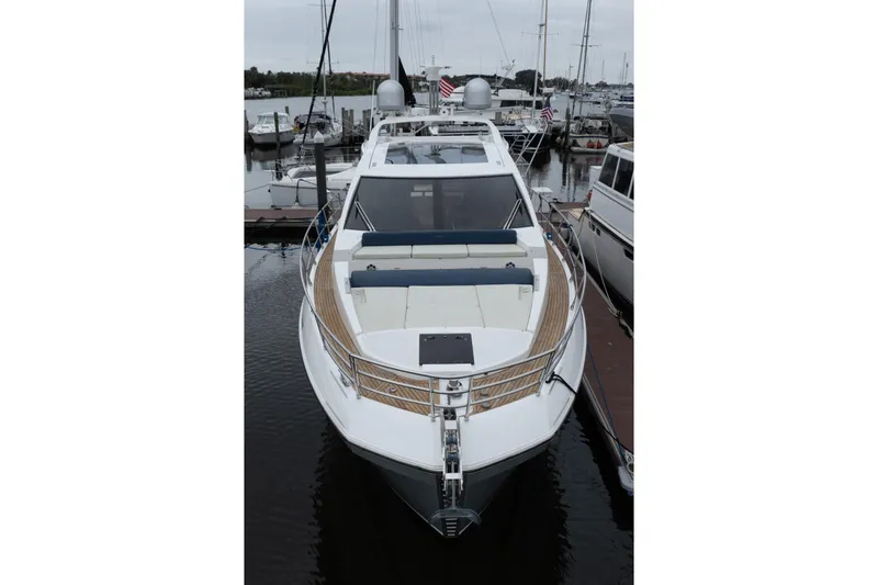 Slide: The Image of 2015 Azimut 55S yacht docked at marina, showcasing sleek design and spacious deck. - 72