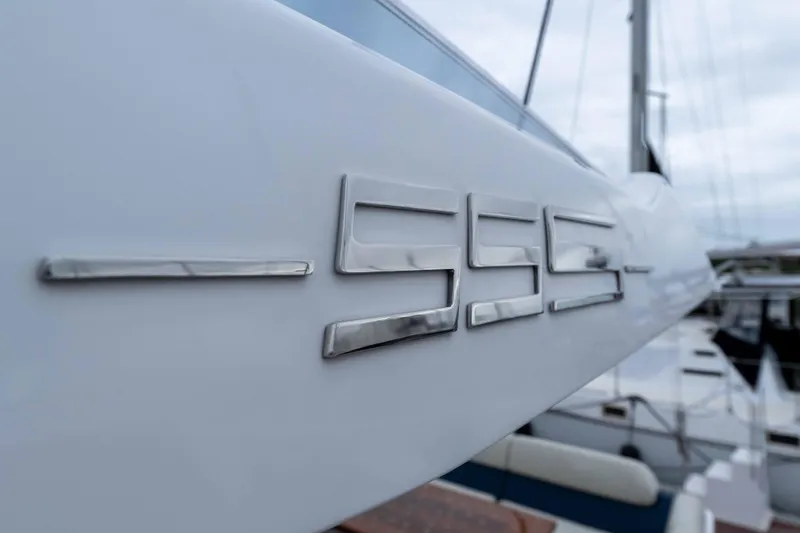 Slide: The Image of 2015 Azimut 55S yacht, close-up of sleek metallic logo on hull. - 78