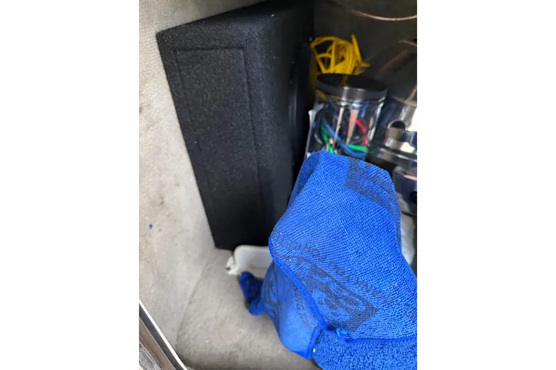 Slide: The Image of Interior of 2007 Sea Ray 280 Cuddy Cabin with blue towel and storage items. - 18