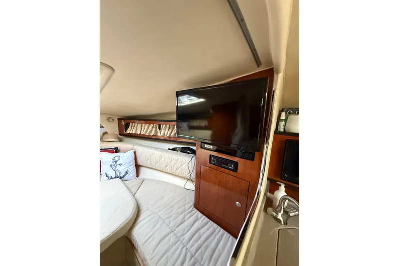 Slide: The Image of 2007 Sea Ray 280 Cuddy Cabin interior with TV, seating, and nautical decor. - 4