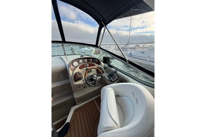 Slide: The Image of 2007 Sea Ray 280 Cuddy Cabin helm with steering wheel and dashboard, docked at marina. - 7