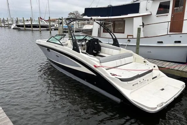 The Image of 2016 Sea Ray 270 Sundeck boat docked in marina, featuring sleek design and spacious seating. - 0