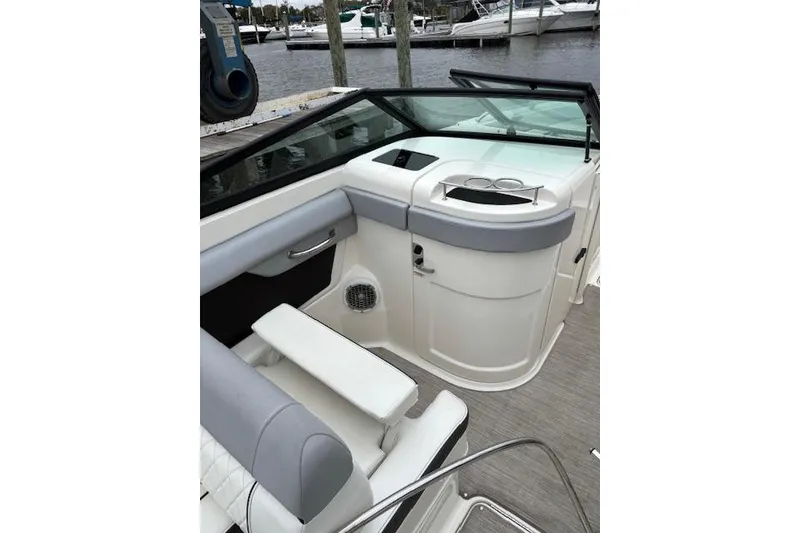 Slide: The Image of 2016 Sea Ray 270 Sundeck interior with seating and storage, docked at marina. - 5