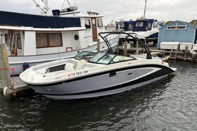 Slide: The Image of 2016 Sea Ray 270 Sundeck boat docked at a marina, side view. - 7