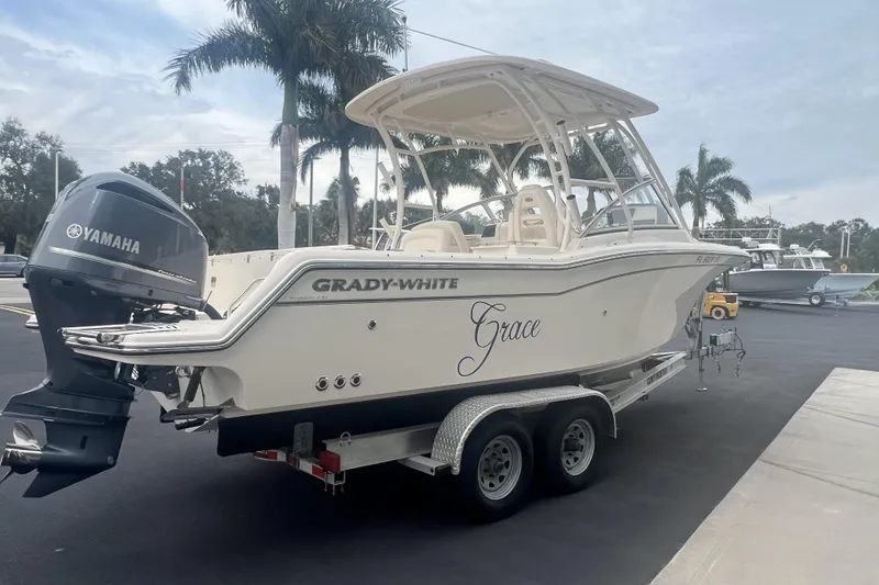 Slide: The Image of 2020 Grady-White Freedom 235 boat interior with luxurious seating and helm station. - 17