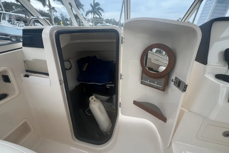 Slide: The Image of 2020 Grady-White Freedom 235 boat interior with Yamaha 300 engine in parking lot. - 8