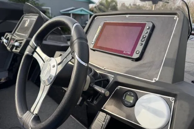 Slide: The Image of 2022 Ranger Z518 Tournament Elite boat dashboard with steering wheel and Lowrance Elite fishfinder. - 12