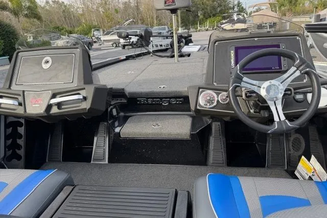 Slide: The Image of 2022 Ranger Z518 Tournament Elite boat interior with steering wheel and dashboard controls. - 13
