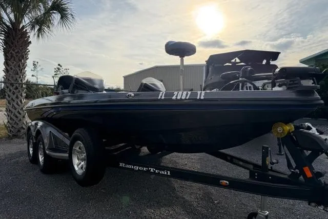 Slide: The Image of 2022 Ranger Z518 Tournament Elite boat on trailer, parked outdoors under a sunny sky. - 2