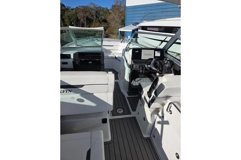 Slide: The Image of 2021 Blackfin 272 DC boat interior with modern dashboard and seating. - 11