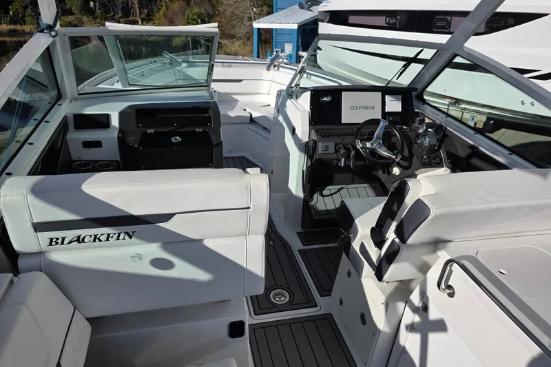 Slide: The Image of 2021 Blackfin 272 DC boat interior with Garmin navigation system and sleek seating. - 12
