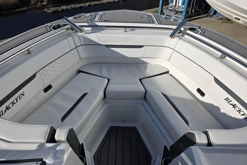 Slide: The Image of 2021 Blackfin 272 DC boat interior with luxurious white seating and sleek design. - 5