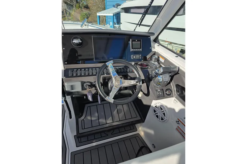 Slide: The Image of 2021 Blackfin 272 DC boat helm with steering wheel and control panel. - 9