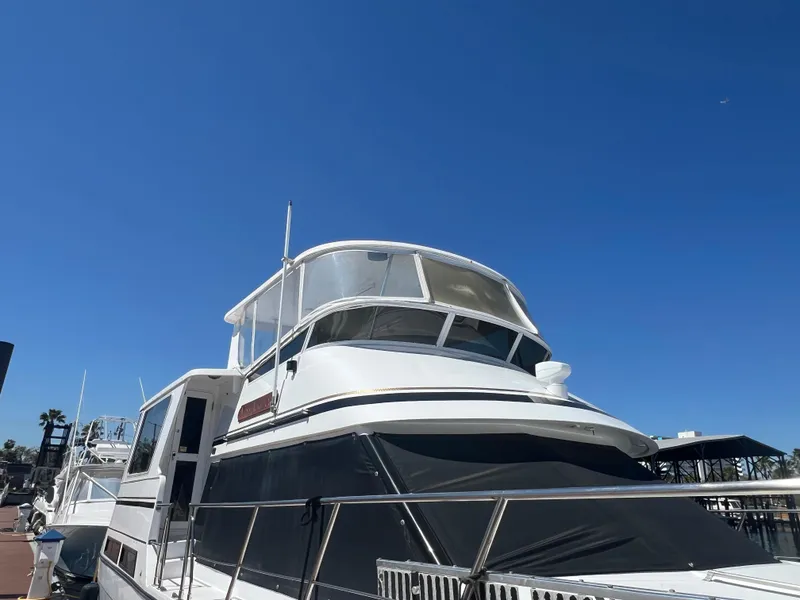 Slide: The Image of 1998 Hyatt 51 Aft Cabin Motor Yacht docked under clear blue sky. - 16