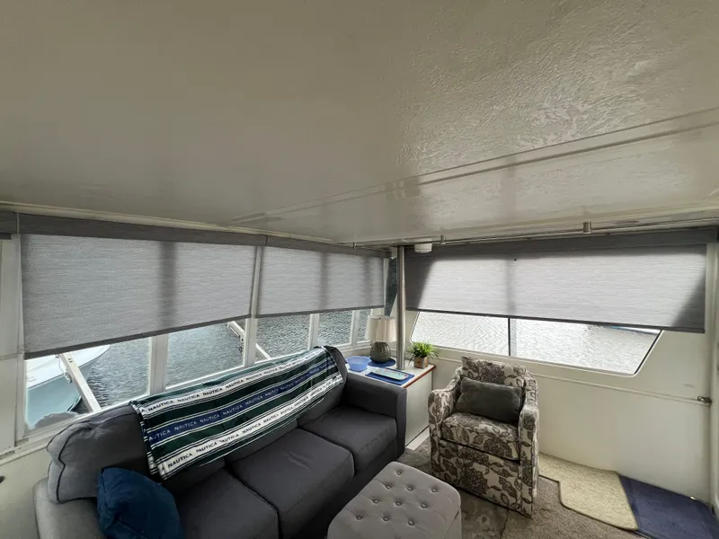Slide: The Image of Interior of 1998 Hyatt 51 Aft Cabin Motor Yacht with cozy seating and large windows. - 27