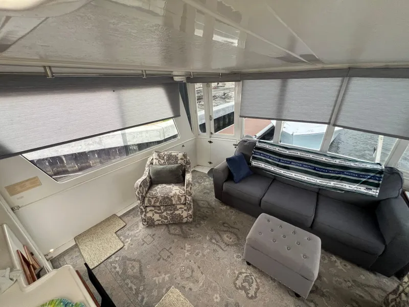 Slide: The Image of Interior of 1998 Hyatt 51 Aft Cabin Motor Yacht with cozy seating and large windows. - 28