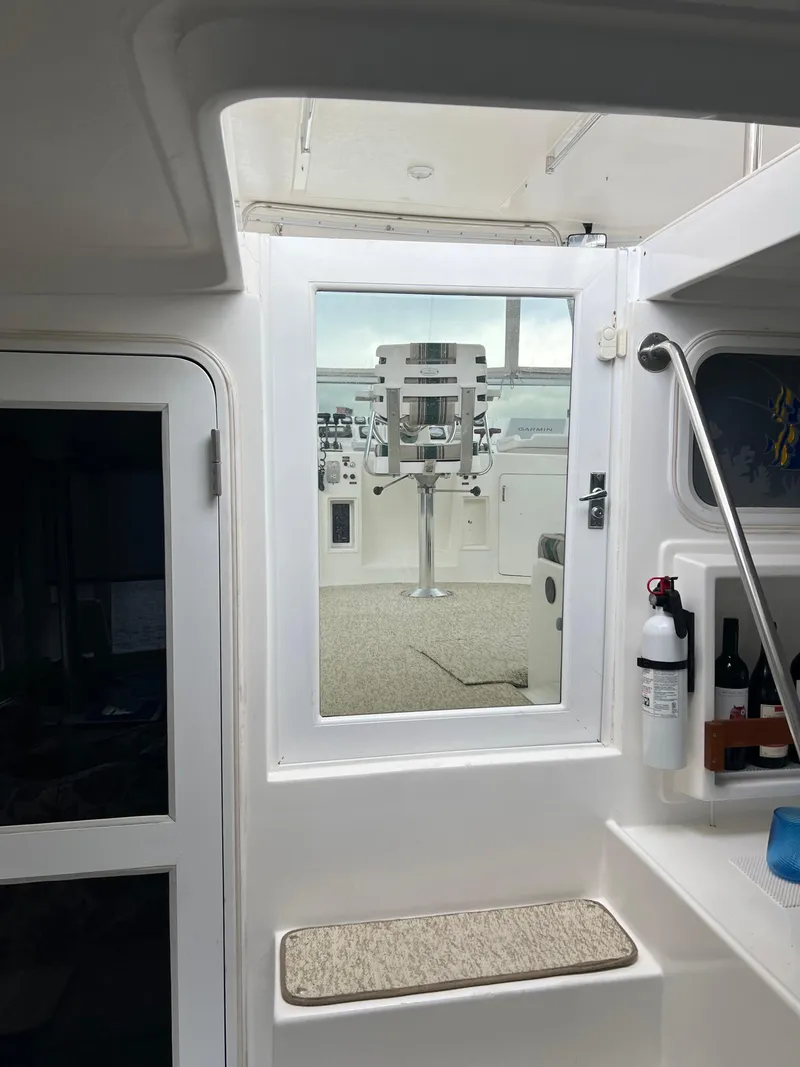 Slide: The Image of Interior view of 1998 Hyatt 51 Aft Cabin Motor Yacht, featuring window and storage area. - 34