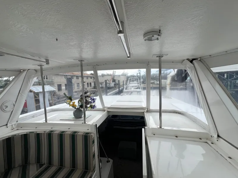 Slide: The Image of 1998 Hyatt 51 Aft Cabin Motor Yacht interior with striped seating and floral arrangement. - 35