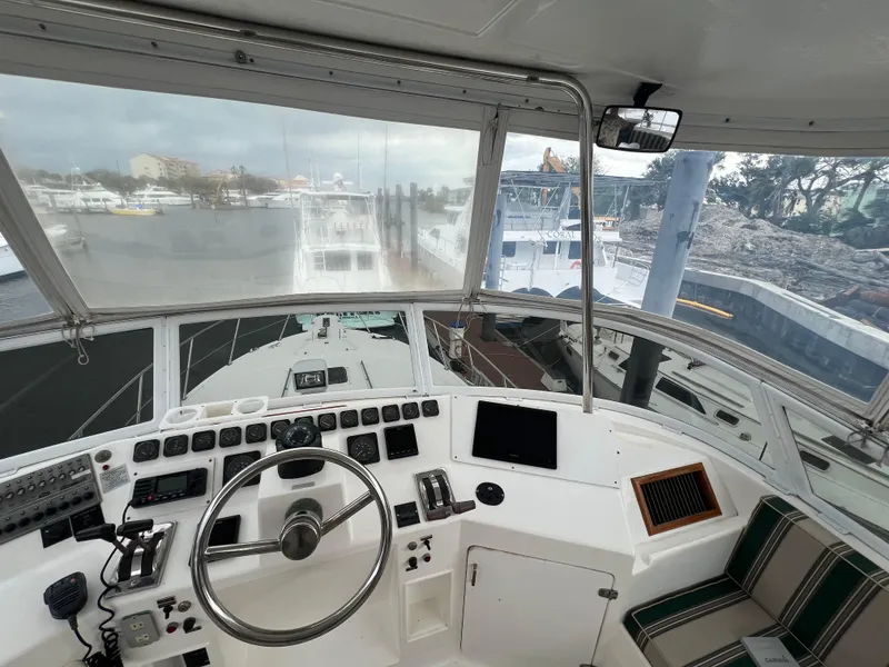 Slide: The Image of Interior view of 1998 Hyatt 51 Aft Cabin Motor Yacht helm with steering wheel and controls. - 44