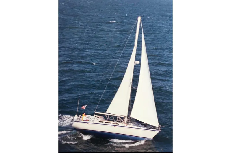 Slide: The Image of 1986 O'Day 40 sailboat navigating open sea with full sails. - 1