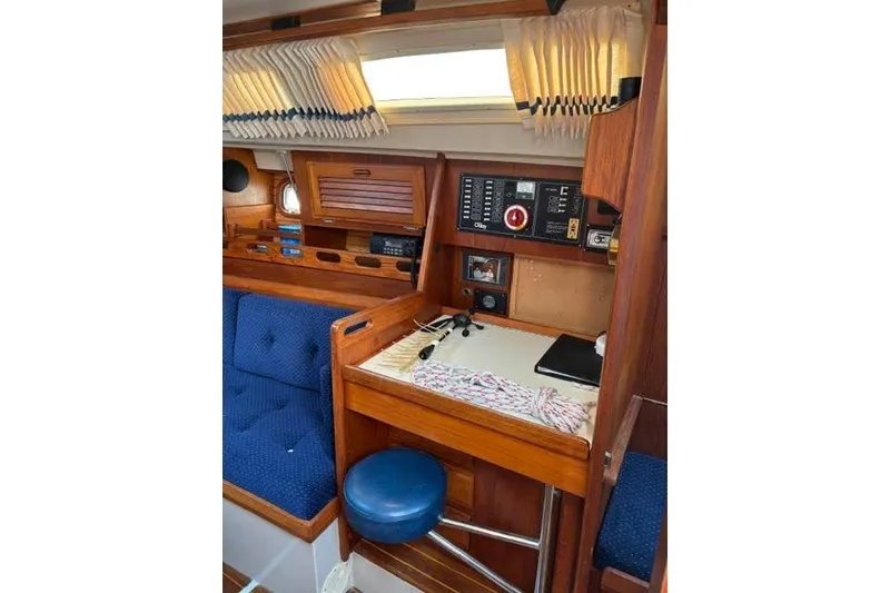Slide: The Image of 1986 O'Day 40 sailboat interior with navigation station and blue seating. - 10