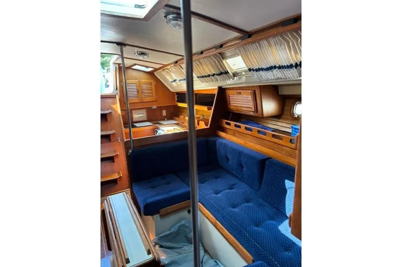 Slide: The Image of Interior of 1986 O'Day 40 sailboat with blue seating and wooden cabinetry. - 19