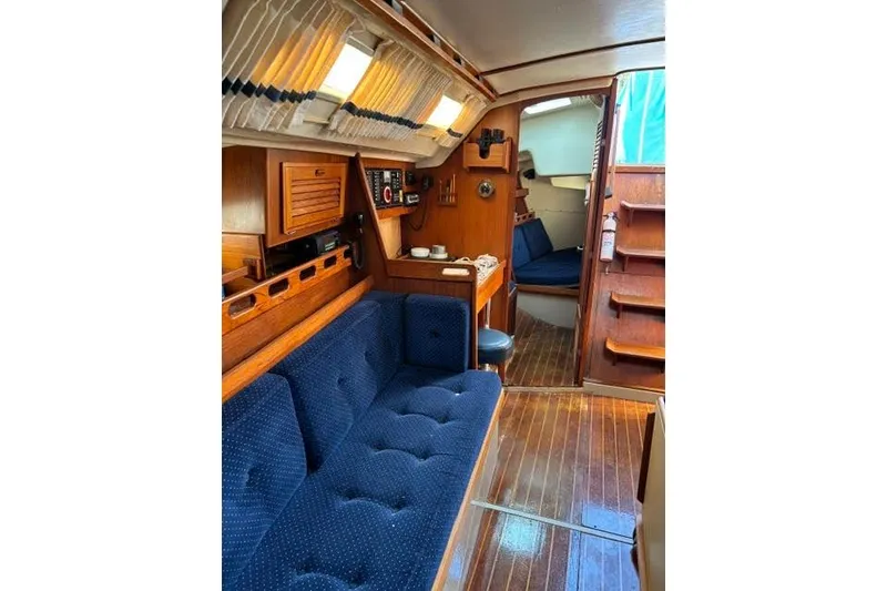 Slide: The Image of Interior of a 1986 O'Day 40 sailboat with blue seating and wooden accents. - 20