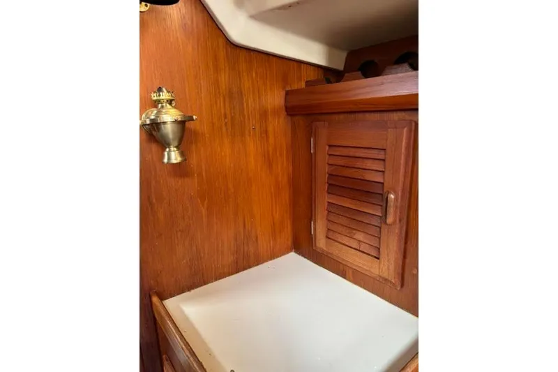 Slide: The Image of Interior of 1986 O'Day 40 sailboat with wooden cabinet and brass lamp. - 21