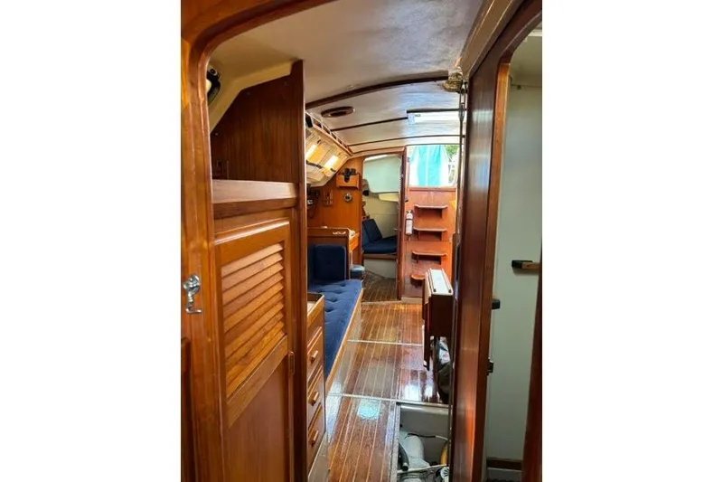 Slide: The Image of Interior of 1986 O'Day 40 sailboat with wooden finishes and blue seating. - 28