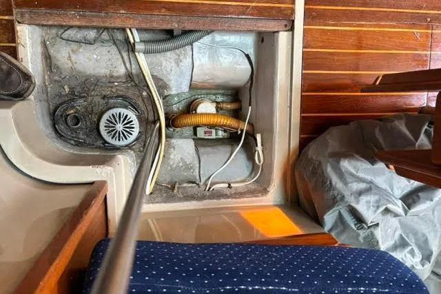 Slide: The Image of 1986 O'Day 40 sailboat interior showing bilge area with pump and wiring. - 29