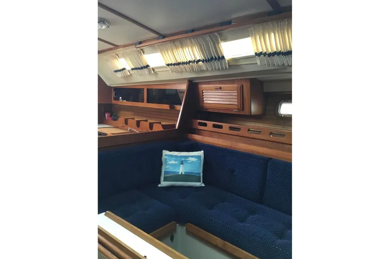 Slide: The Image of Interior of 1986 O'Day 40 sailboat with blue seating and wooden cabinetry. - 7