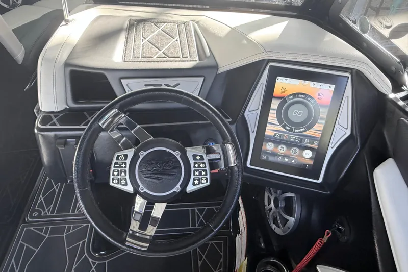 Slide: The Image of 2021 Tigé 23ZX boat interior with luxurious black and white seating and speaker system. - 24