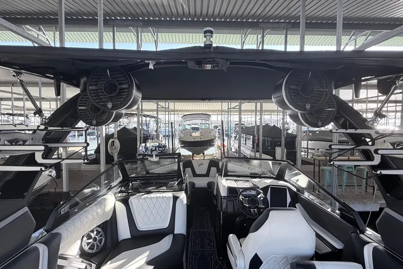 Slide: The Image of 2021 Tigé 23ZX boat interior with speakers and safety labels. - 28