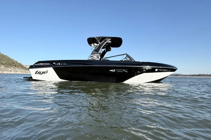 Slide: The Image of 2021 Tigé 23ZX boat on water under clear blue sky. - 7