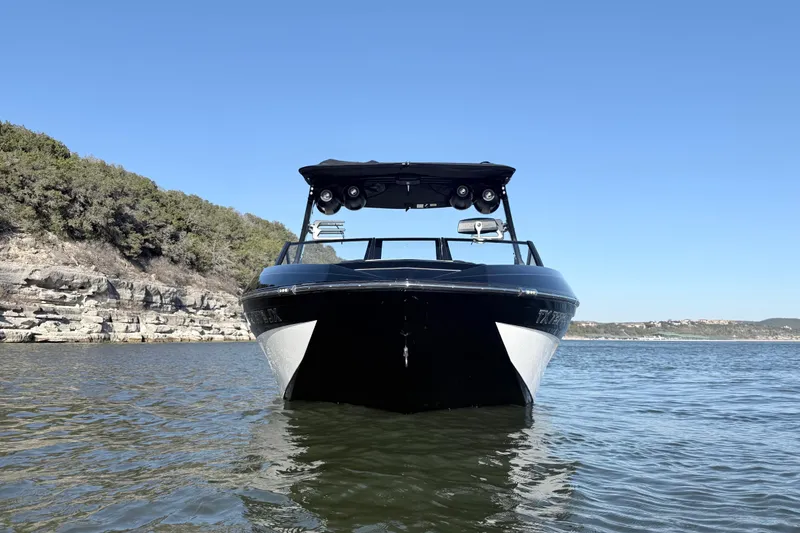 Slide: The Image of 2021 Tigé 23ZX boat on trailer, parked on road with scenic background. - 9