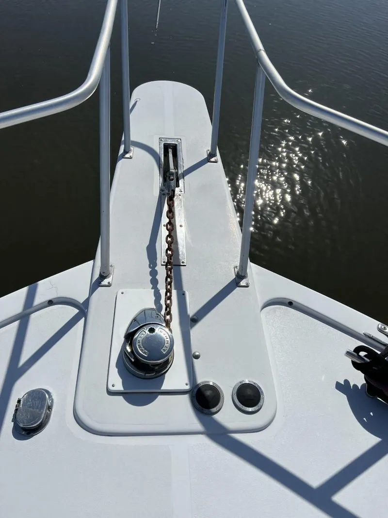 Slide: The Image of Bow of 1991 Viking Convertible boat with anchor chain and railing. - 14