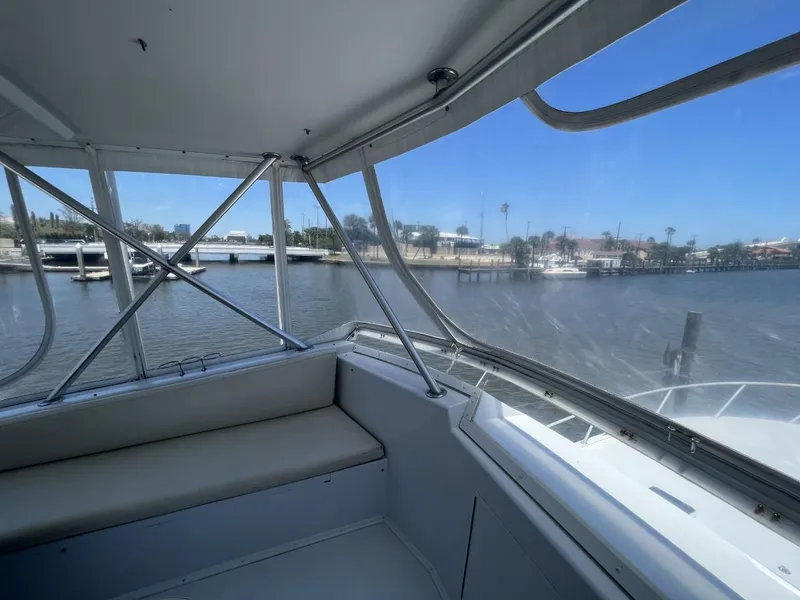 Slide: The Image of Interior view of a 1991 Viking Convertible yacht by the water. - 23