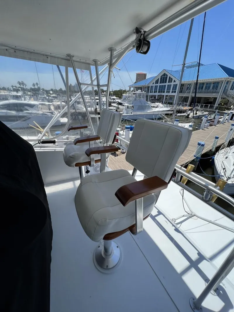 Slide: The Image of 1991 Viking Convertible yacht with white seats in marina. - 24