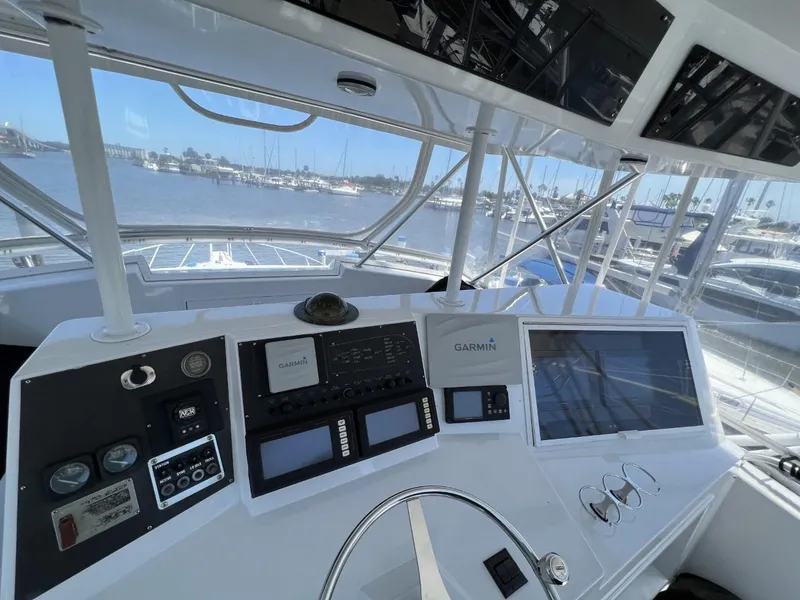 Slide: The Image of Helm of a 1991 Viking Convertible boat with modern electronics. - 28