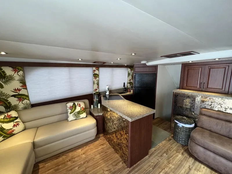 Slide: The Image of Luxurious interior of a 1991 Viking Convertible yacht with modern kitchen and seating area. - 39