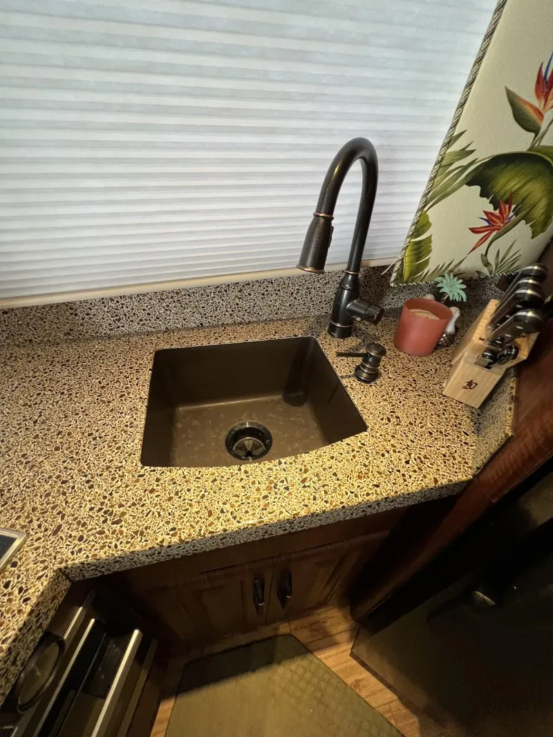 Slide: The Image of 1991 Viking Convertible kitchen sink with modern faucet and decorative countertop. - 48
