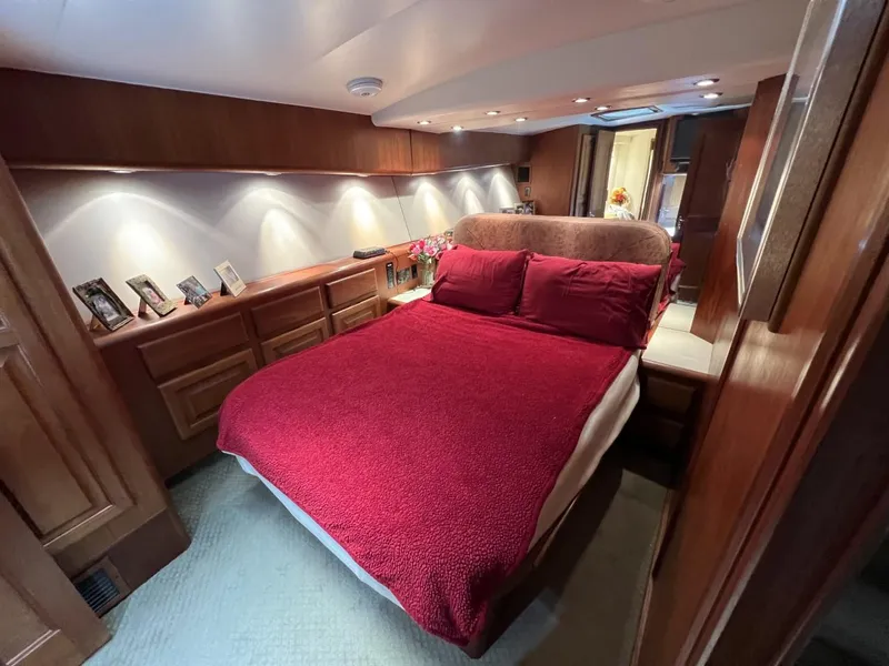 Slide: The Image of Luxurious bedroom interior of a 1991 Viking Convertible yacht with red bedding. - 62