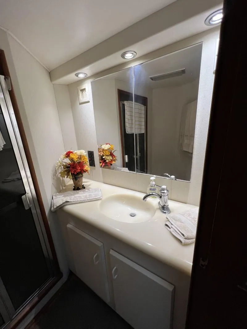 Slide: The Image of Bathroom vanity in a 1991 Viking Convertible, featuring a mirror, sink, and floral decor. - 67