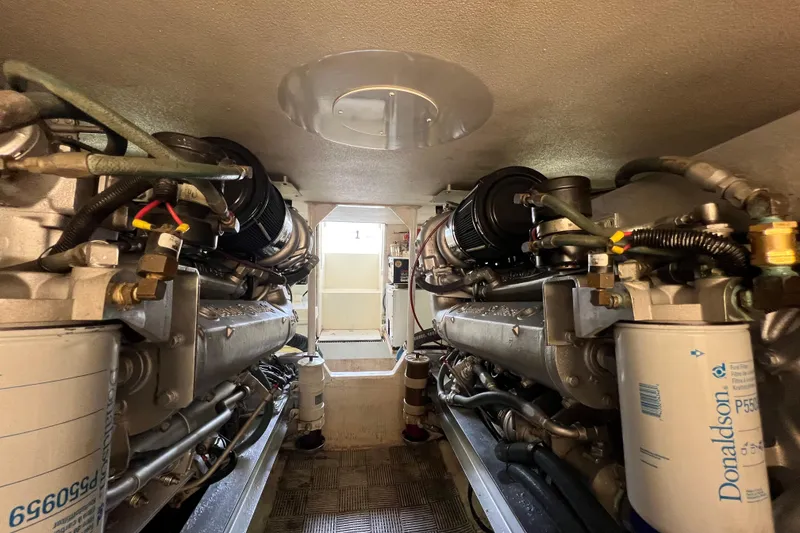 Slide: The Image of Engine room of a 1991 Viking Convertible boat, showcasing dual engines and mechanical components. - 71
